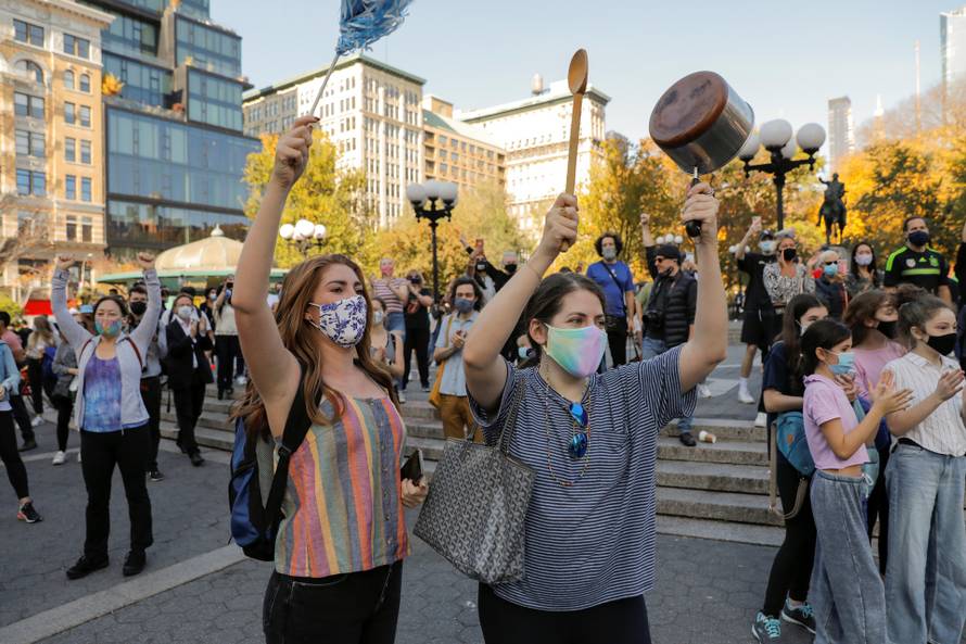 People celebrate media announcing that Democratic U.S. presidential nominee Joe Biden has won the 2020 U.S. presidential election in the Alphabet City neighborhood of Manhattan