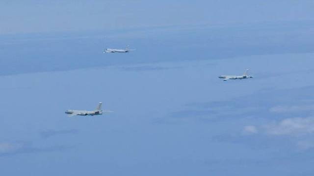 A Russian TU-95 bomber and Chinese H-6 bombers fly over East China Sea in this handout picture
