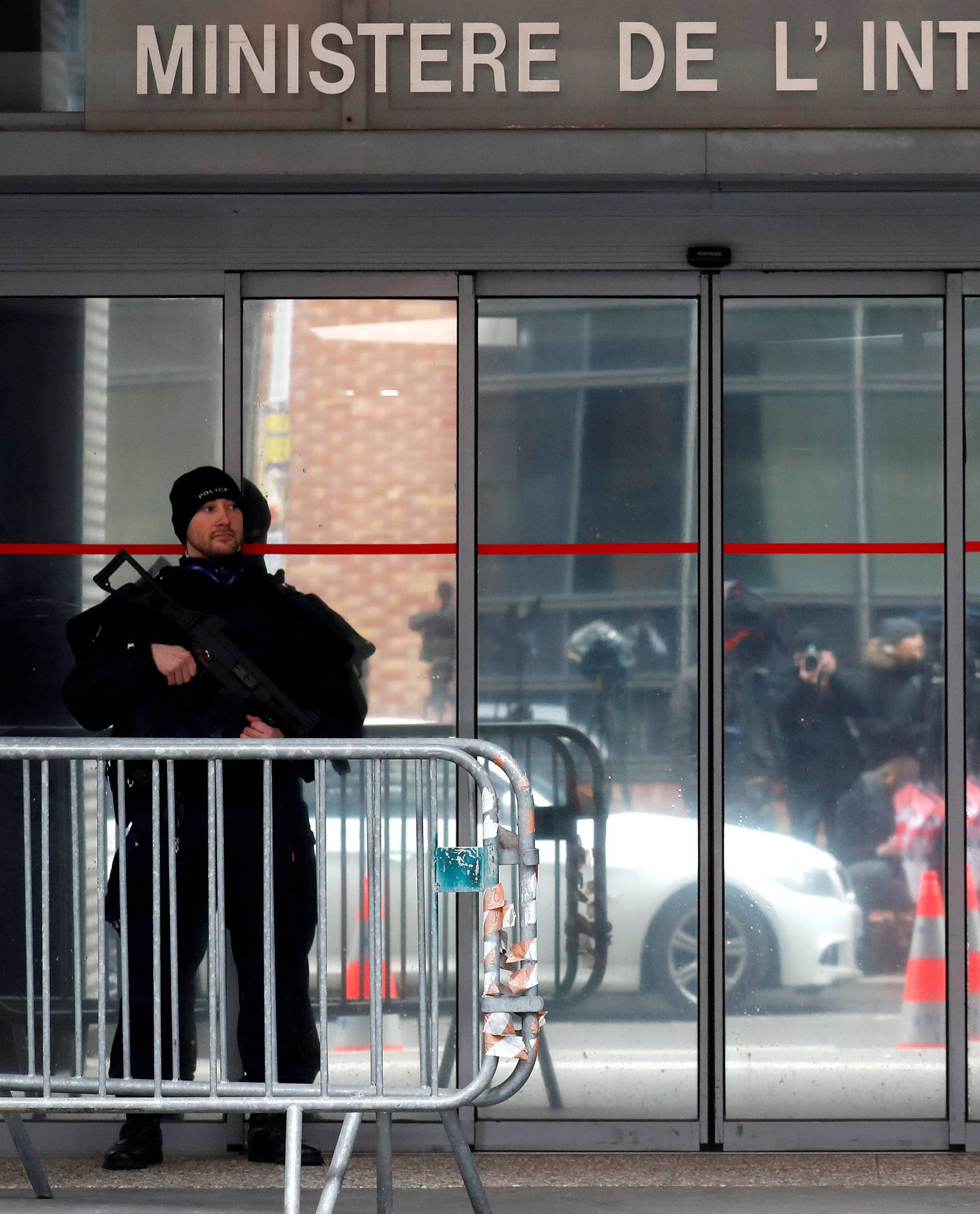 A French policeman stands guard in front of the entrance of the judiciary police offices in Nanterre