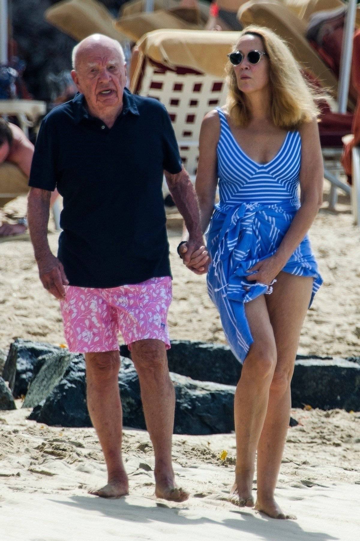 *EXCLUSIVE* Jerry Hall catches her husband Rupert Murdoch as he stumbles on the beach