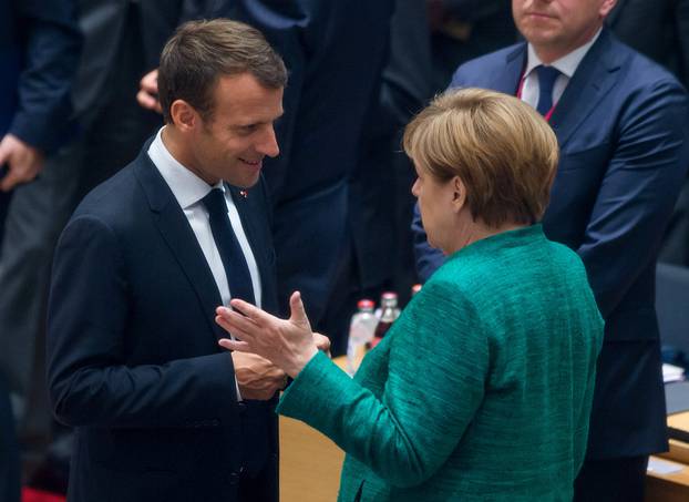French President Emmanuel Macron and German Chancellor Angela Merkel take part in a European Union summit in Brussels