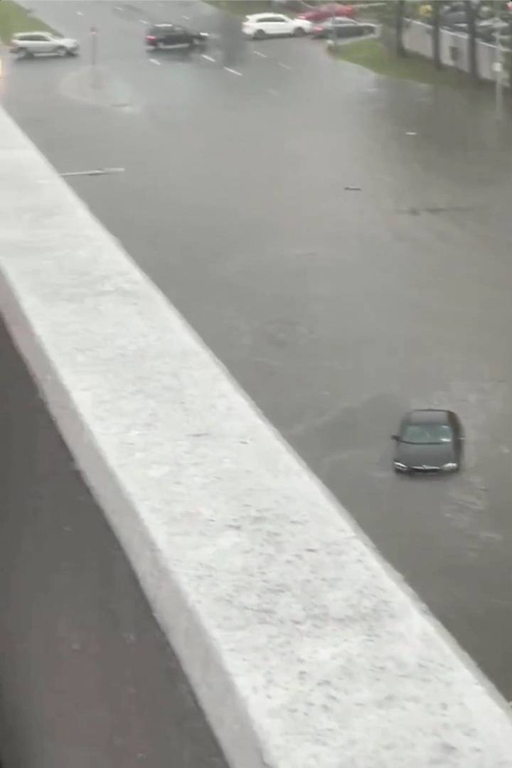 Cars are seen on a flooded street in Yonkers