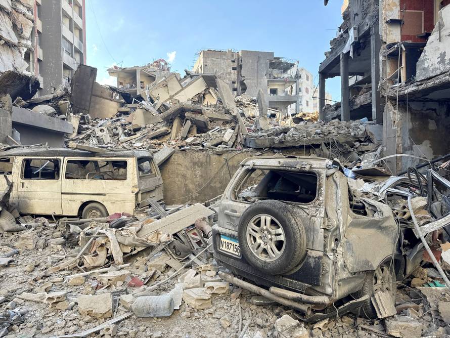 A damaged building and cars after an Israeli strike, following renewed hostilities between Hezbollah and Israel amid the U.S.-Israeli conflict with Iran