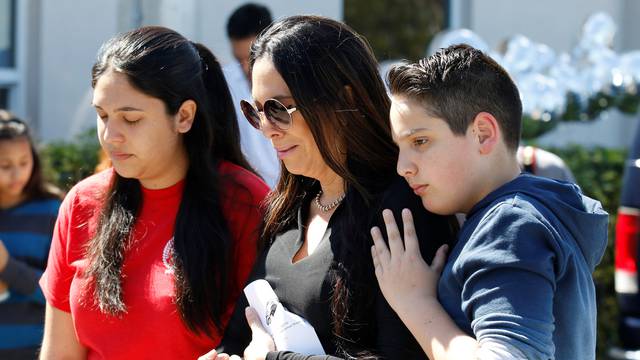 Students and parents from Marjory Stoneman Douglas High School attend a memorial following a school shooting incident in Parkland