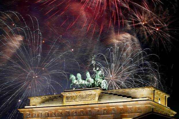 Fireworks explode over the Quadriga sculpture atop the Brandenburg gate during New Year celebrations in Berlin, Germany