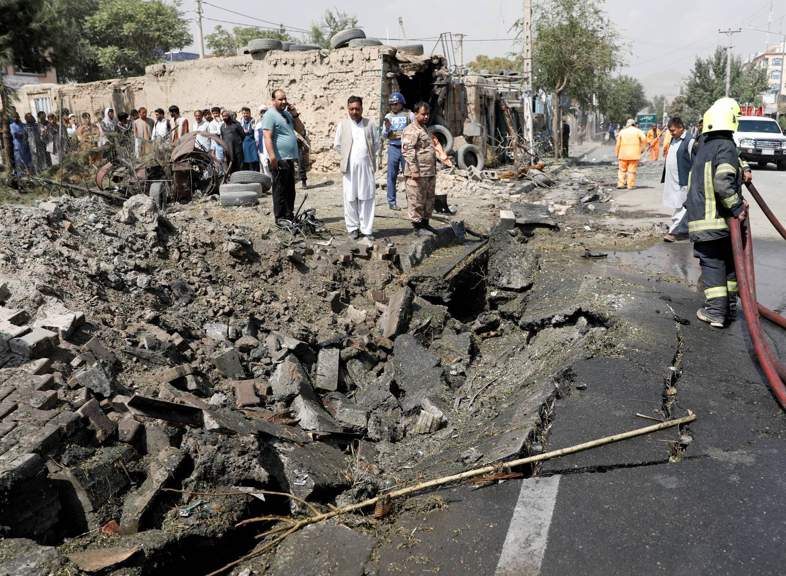 Afghan men gather at the site of a blast in Kabul