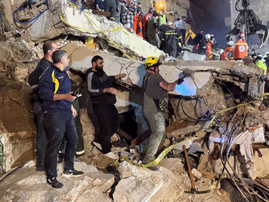 Rescue teams search for survivors after a building collapsed in Tripoli