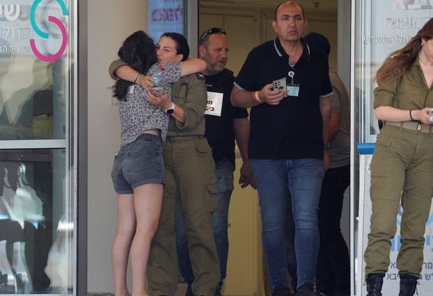 Families of hostages walk towards a hospital to meet with released hostages, in Ramat Gan