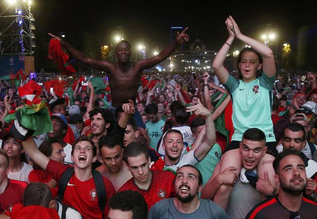 Portugal fans react at Paris fan zone during a EURO 2016 final soccer match       