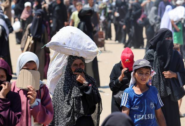 Palestinians seek aid from the U.S.-backed Gaza Humanitarian Foundation, near Rafah