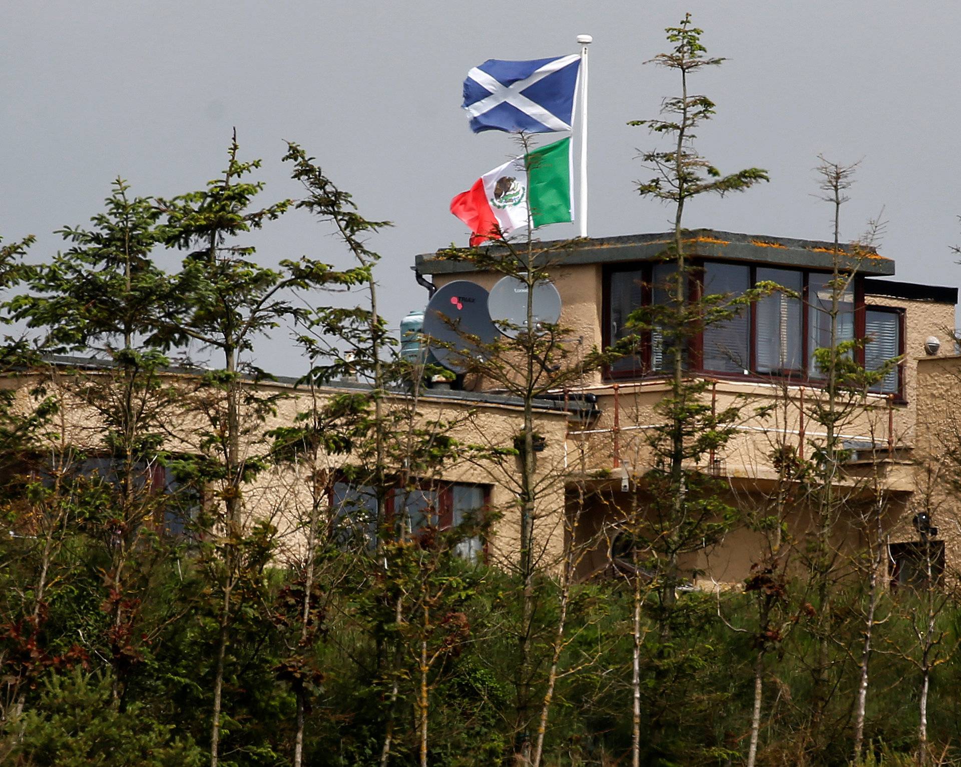 A home that overlooks Trump International Golf Links flies Mexican and Scottish flags before the arrival of Republican presidential candidate Donald Trump in Aberdeen