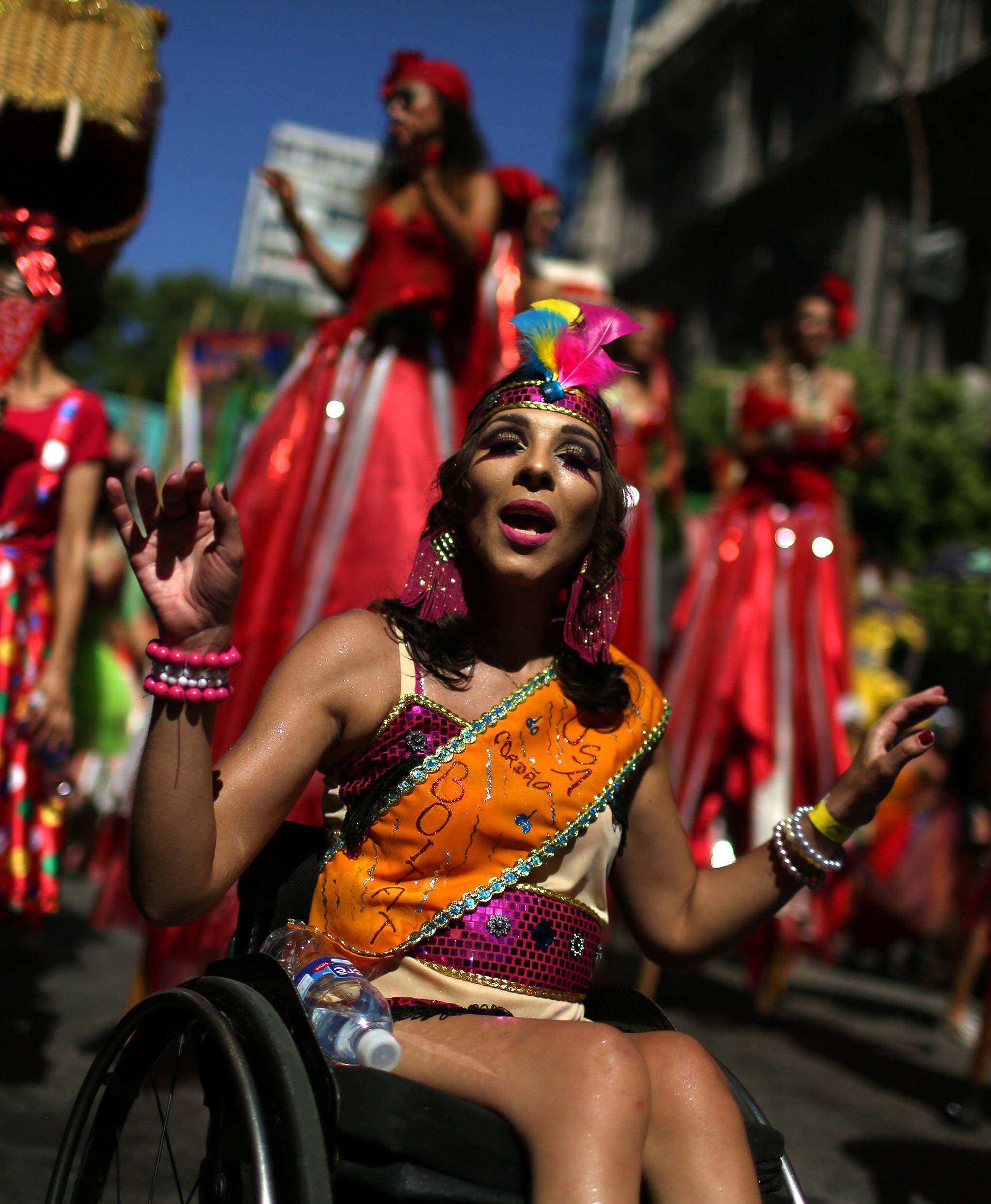 A reveller in a weelchair takes part in the annual block party Cordao do Boitata during pre-carnival festivities in Rio Janeiro