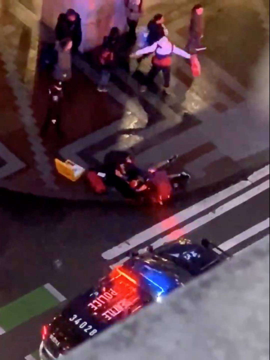 Police and emergency officials attend to the injured following a shooting in Seattle