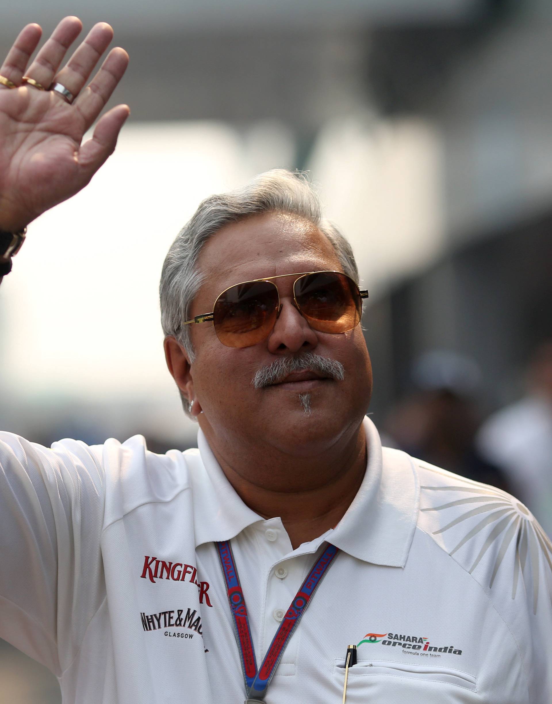 FILE PHOTO: Force India team principal Vijay Mallya waves in the paddock during the third practice session of the Indian F1 Grand Prix at the Buddh International Circuit in Greater Noida
