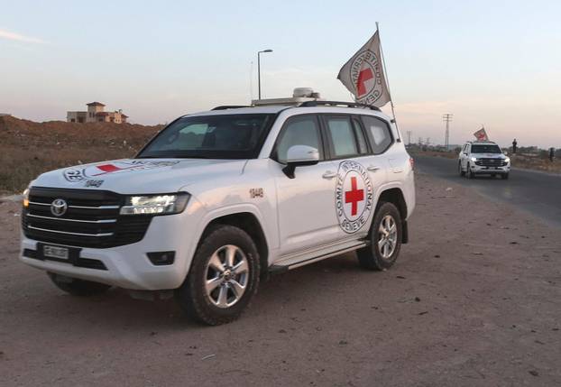 Hamas militants hand over Israeli-American hostage Edan Alexander to the International Red Cross, in Gaza