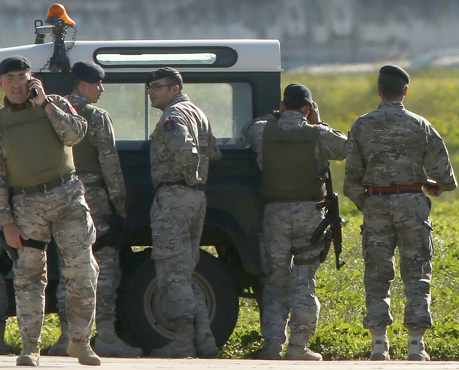 Maltese troops survey a hijacked Libyan Afriqiyah Airways Airbus A320 on the runway at Malta Airport