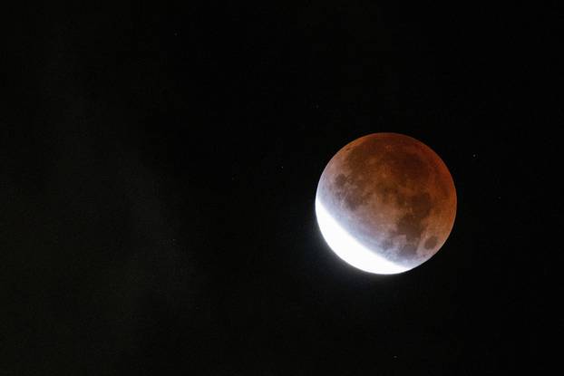 The moon undergoes a partial lunar eclipse as seen from New York City, New York