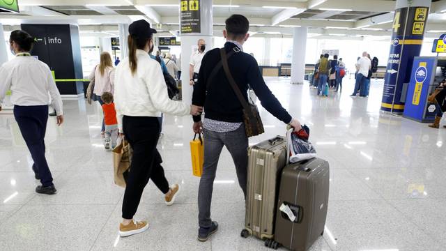Passengers wearing protective face masks arrive at Son Sant Joan airport in Palma de Mallorca