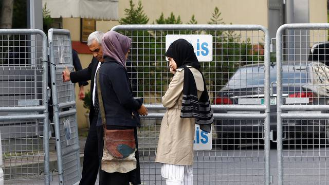 Fiancee of Saudi journalist Jamal Khashoggi and her friend wait outside Saudi Arabia's consulate in Istanbul