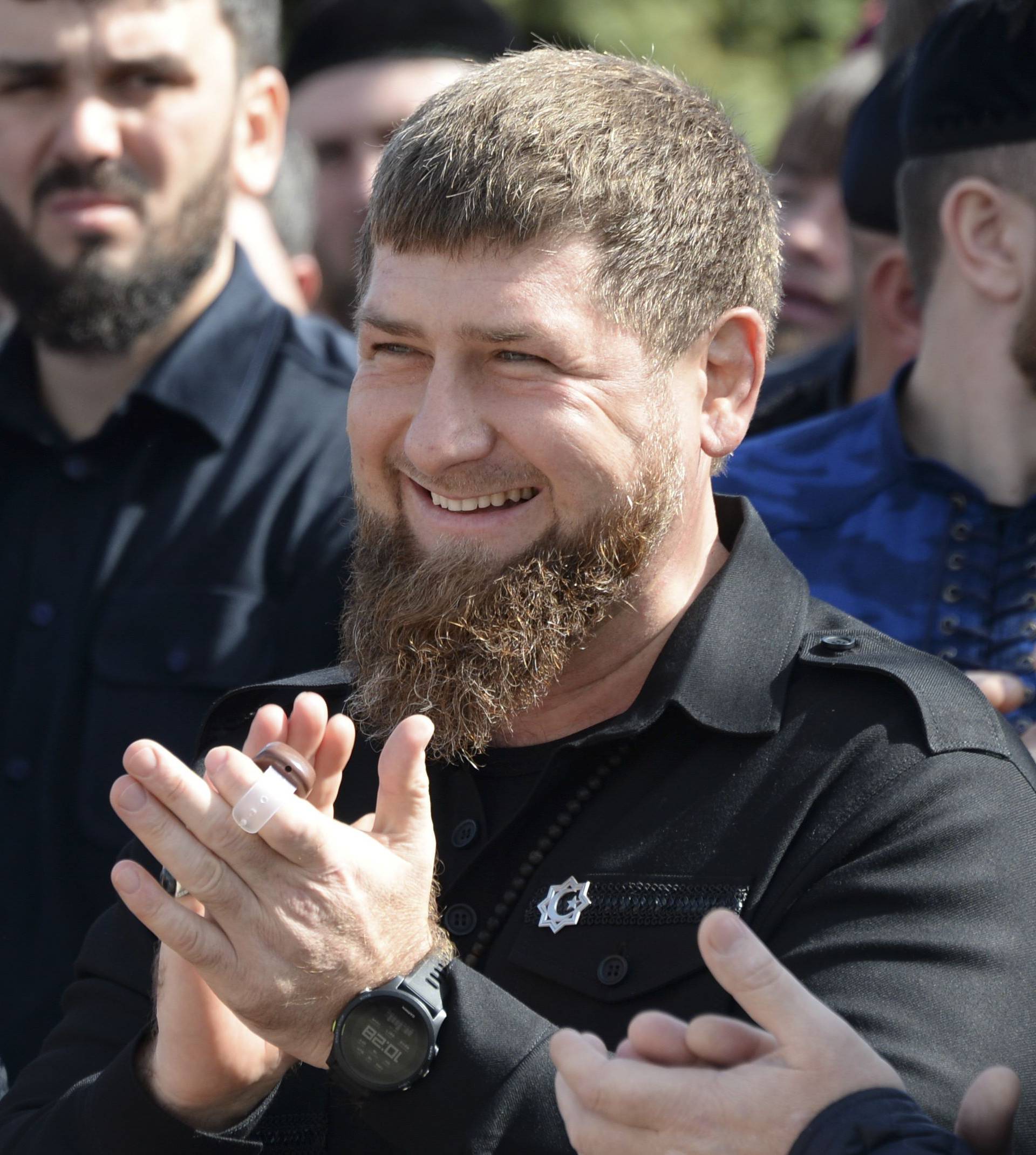 Head of the Chechen Republic Kadyrov applauds after visiting a polling station during the presidential election in Tsentoroy