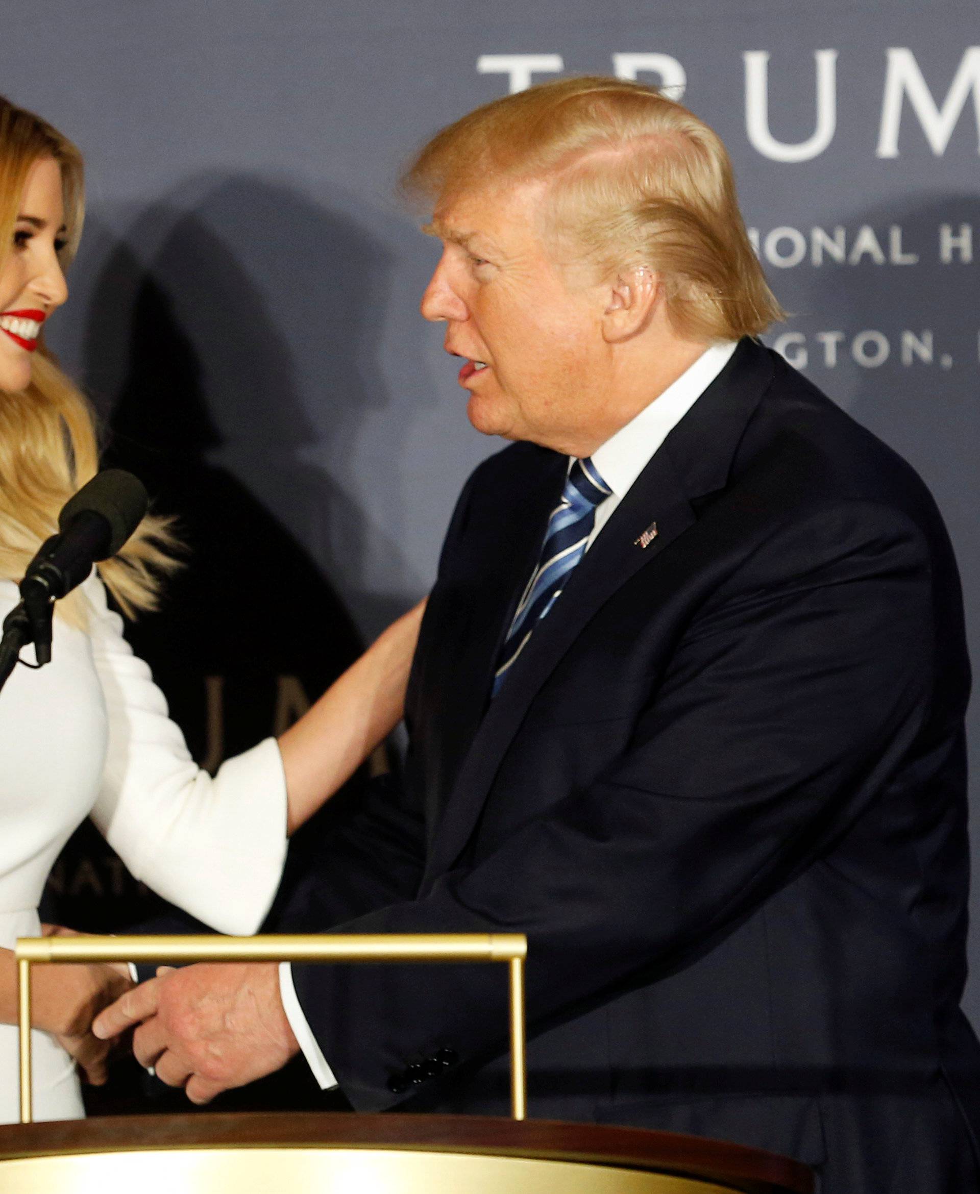 Republican US presidential nominee Trump shakes hand of daughter Ivanka at official ribbon cutting ceremony in Washington
