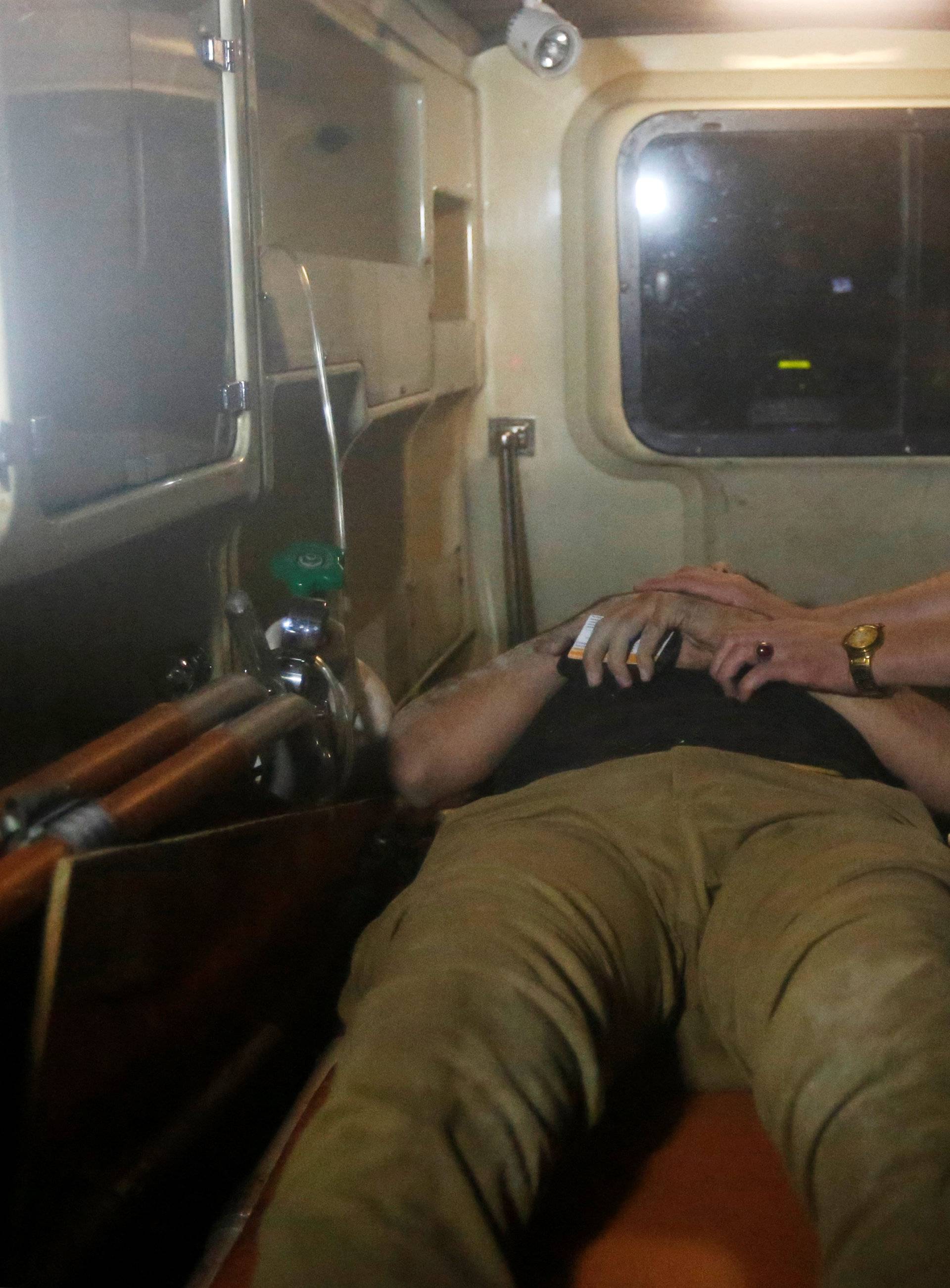 A wounded man lies inside an ambulance following an attack at American University of Afghanistan in Kabul