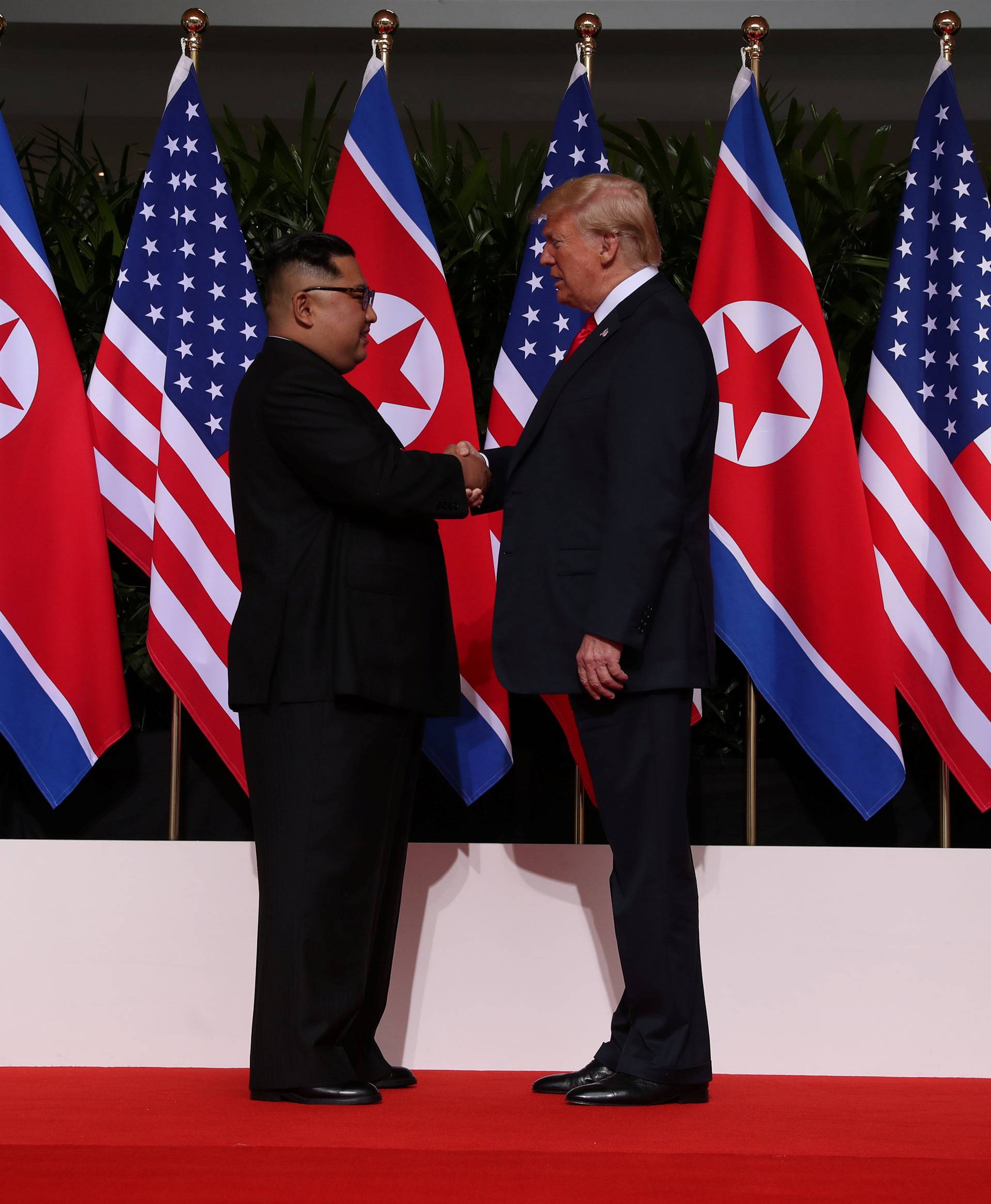 U.S. President Donald Trump shakes hands with North Korean leader Kim Jong Un at the Capella Hotel on Sentosa island in Singapore