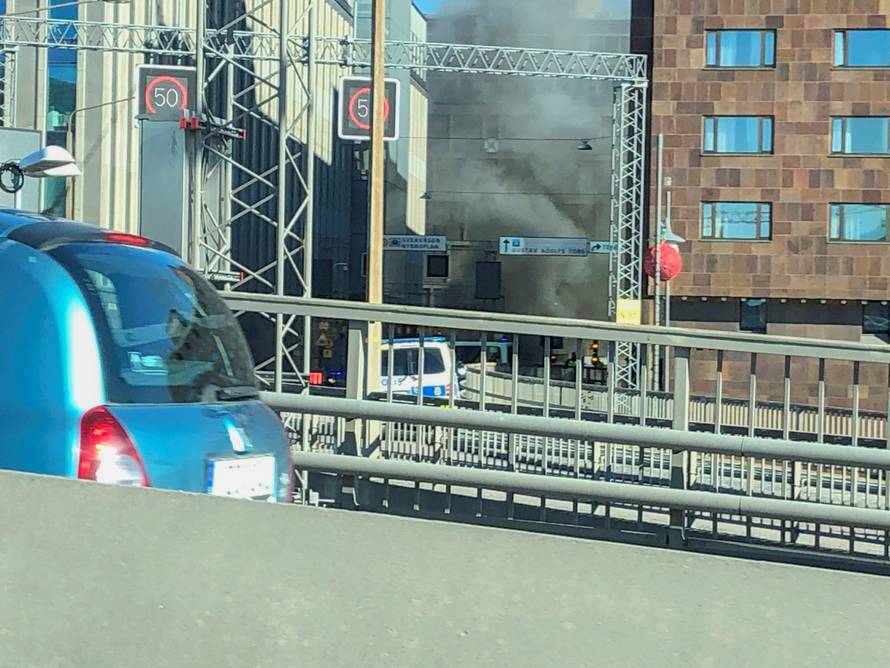 Smoke from a bus explosion and fire is seen in Tegelbacken in central Stockholm