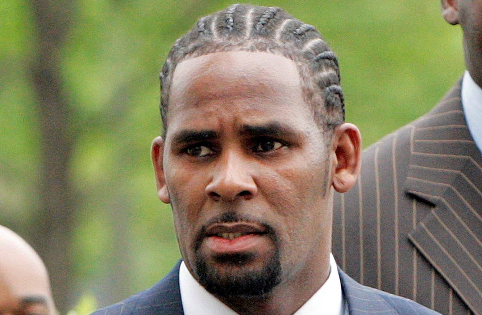 FILE PHOTO: Recording artist R. Kelly arrives at the Cook County Criminal Courthouse for the first day of his trial in Chicago