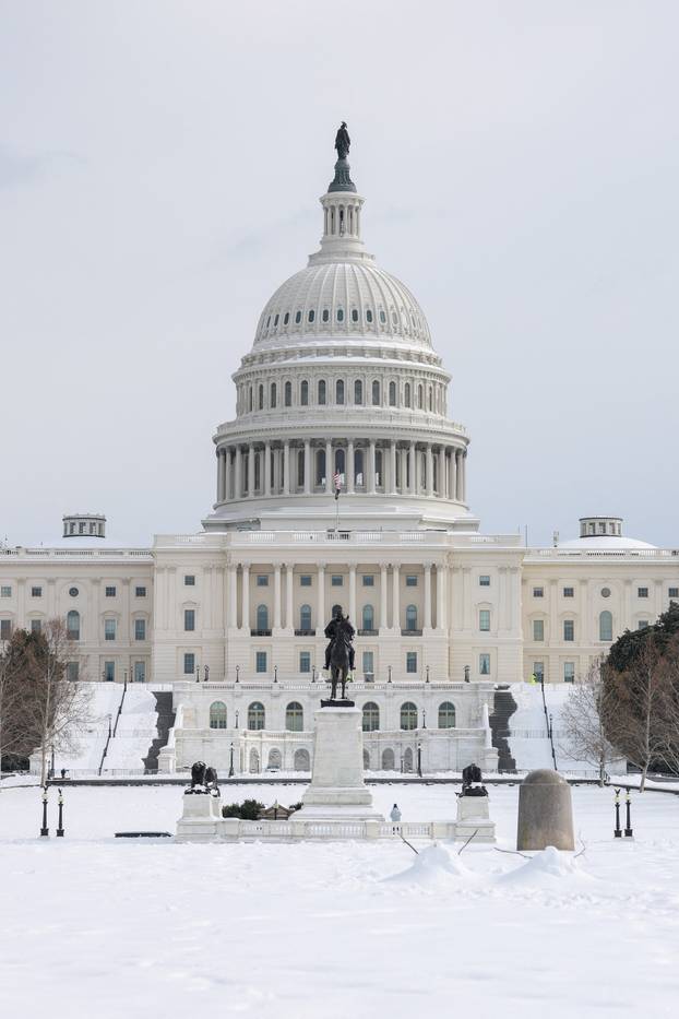 Snow covers the ground in front of the U.S. Capitol building after a winter storm in Washington
