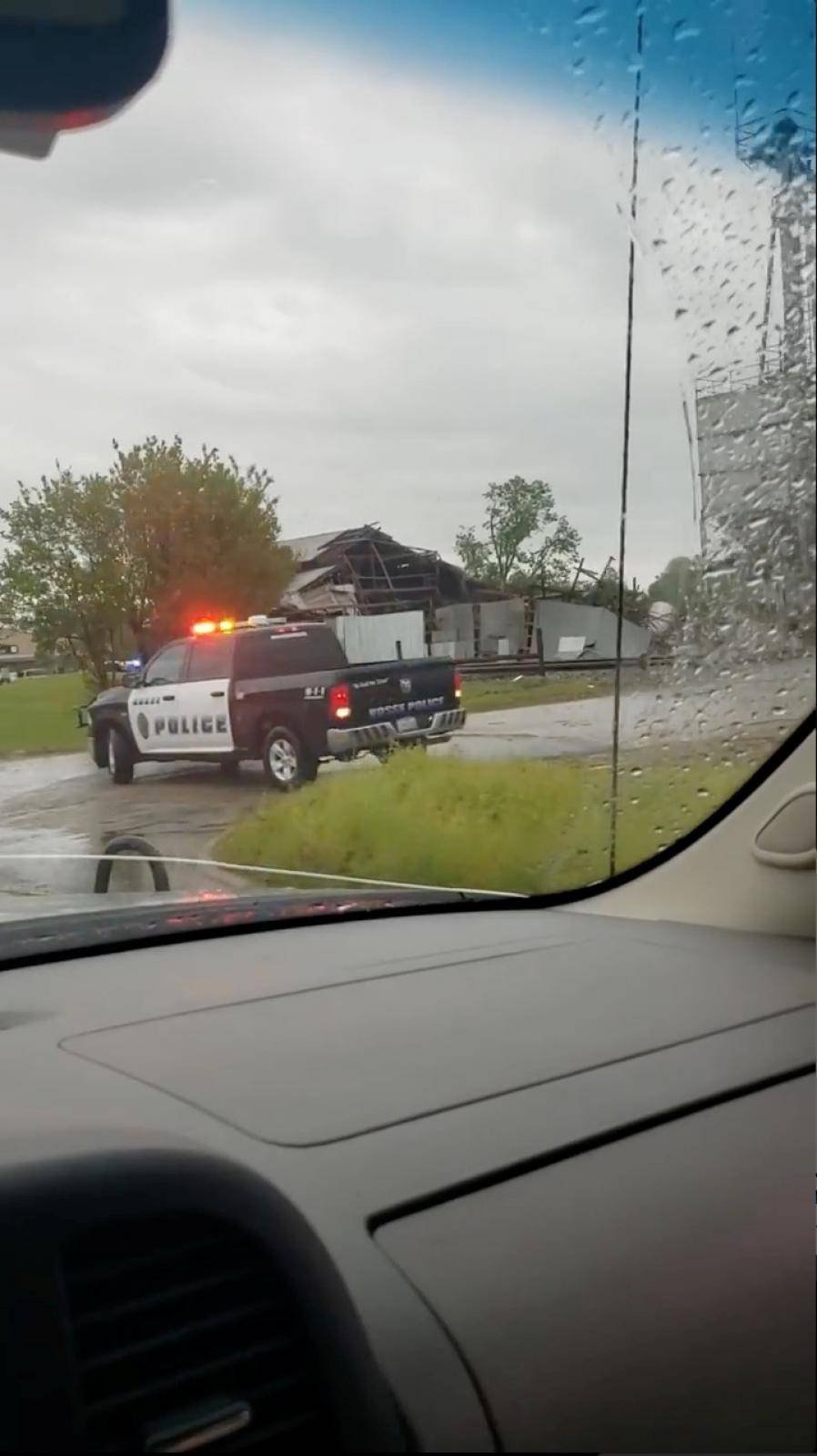 Police vehicle seen next to a damaged property in the aftermath of a tornado in Franklin, Texas, U.S., in this still image from social media video