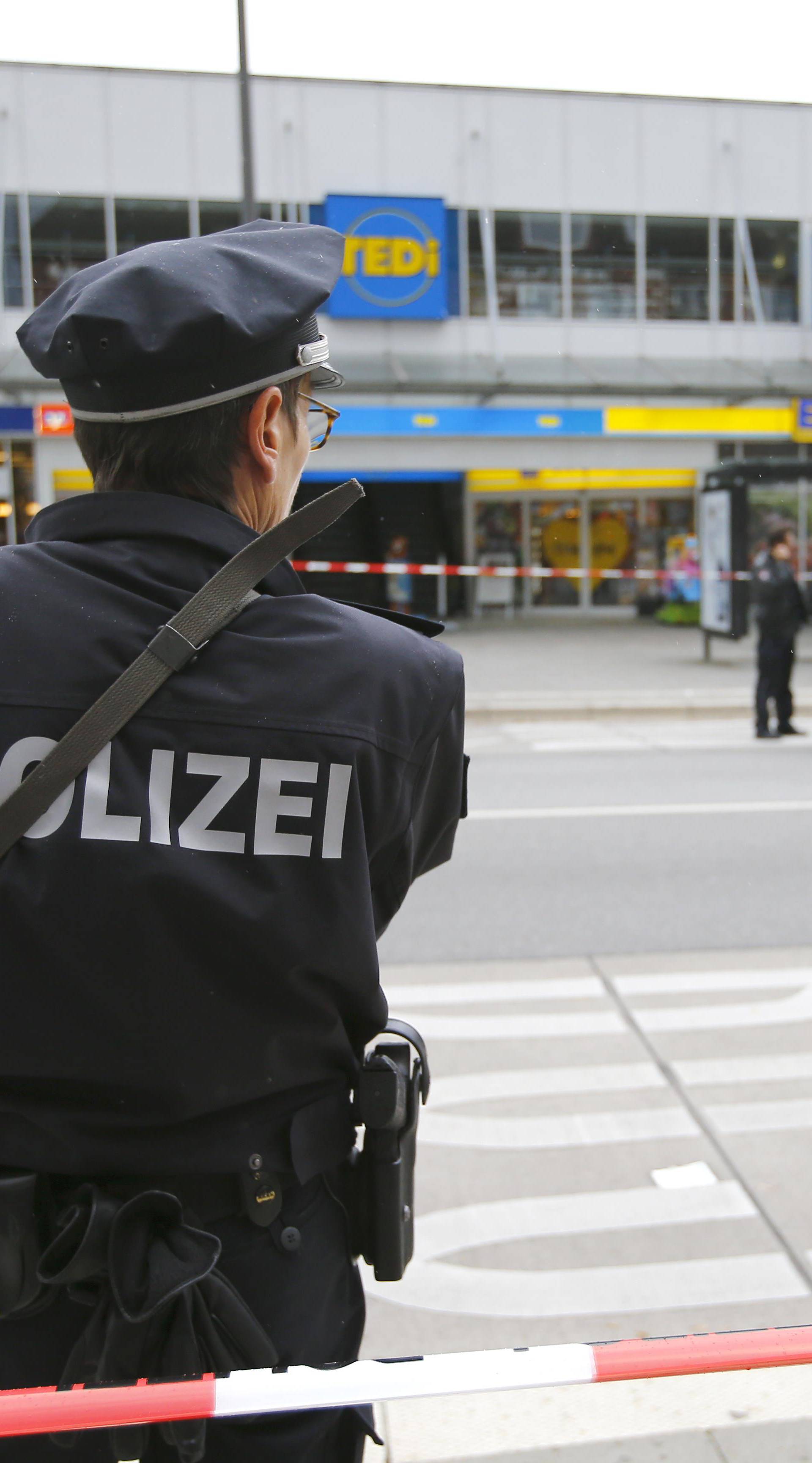 A police officer looks on after a knife attack in a supermarket in Hamburg