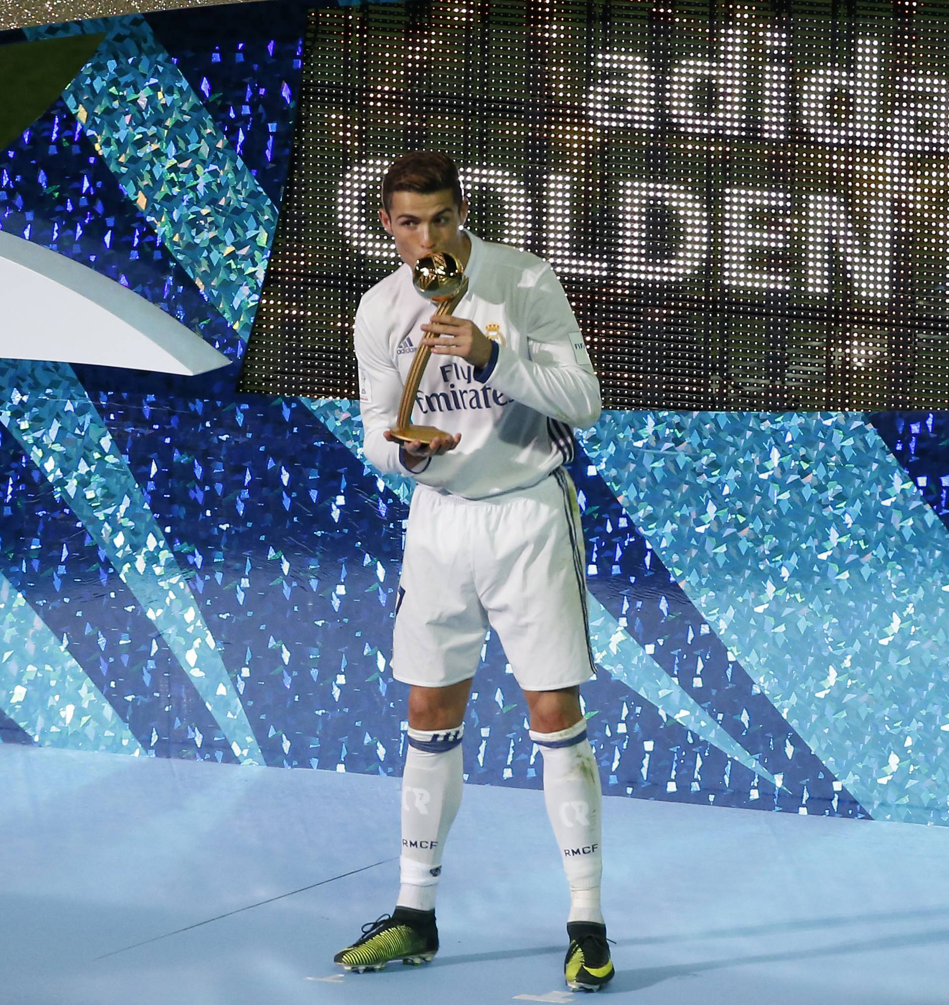 Real Madrid's Cristiano Ronaldo celebrates with the Golden Ball trophy