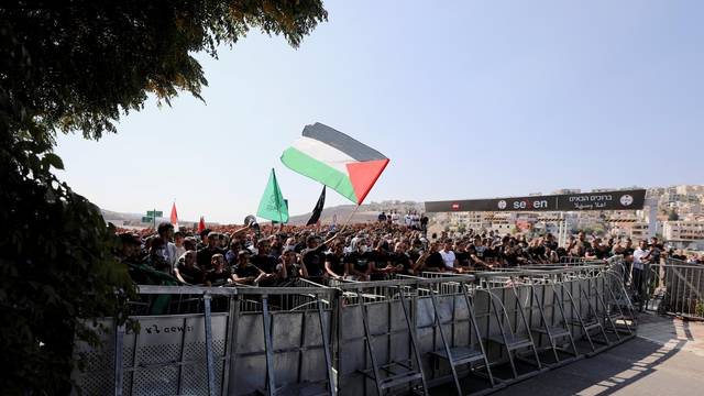 Arab citizens of Israel, who often identify as Palestinian, wave a Palestinian flag during a demonstration against a wave of violent crime within their communities, in the mostly Arab town of Umm el Fahm, in northern Israel