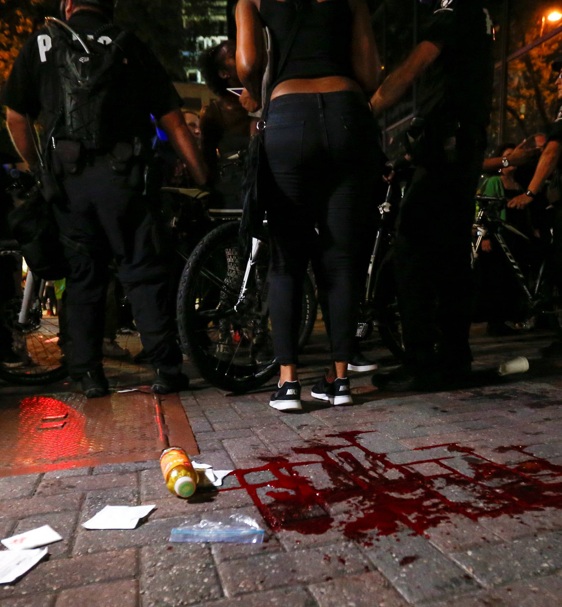 Blood covers the pavement where a person was shot in uptown Charlotte, NC during a protest of the police shooting of Keith Scott, in Charlotte