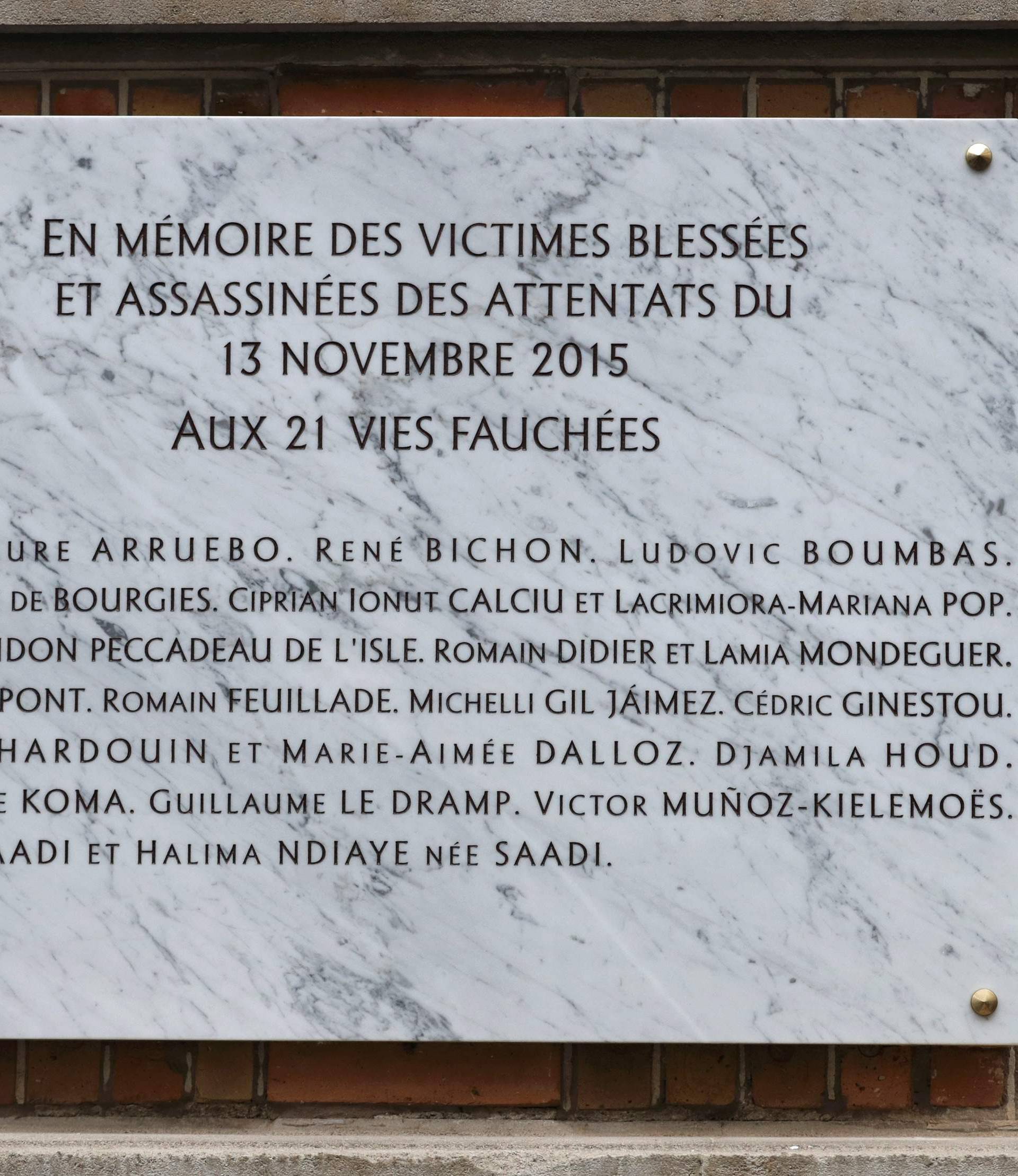 A commemorative plaque unveiled by French President Francois Hollande and Paris Mayor Anne Hidalgo is seen next to the "La Belle Equipe" bar and restaurant in Paris