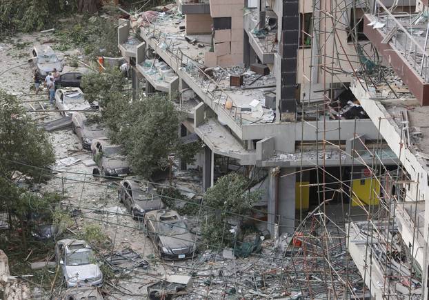 FILE PHOTO: People inspect the damage near the site of Tuesday