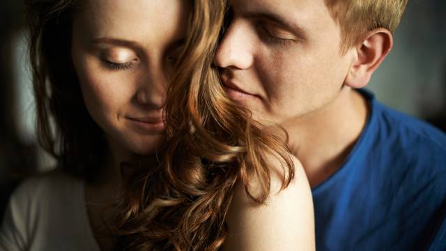 Young,Man,Enjoying,Smell,Of,Hair,Of,His,Sweetheart