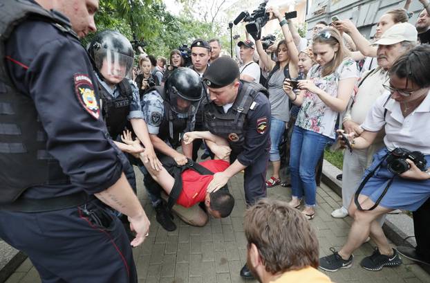 Law enforcement officers detain a participant of a rally in support of Russian investigative journalist Ivan Golunov in Moscow