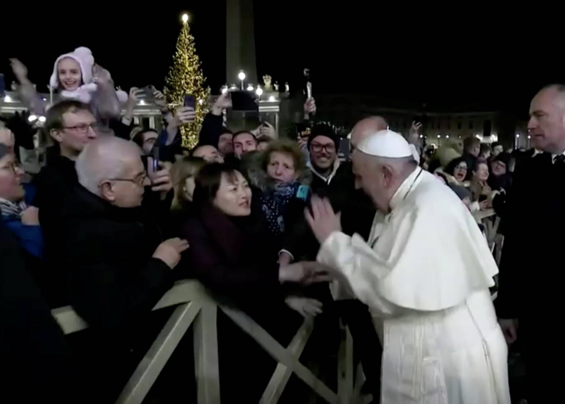 Pope Francis slaps the hand of a woman who grabbed him, at Saint Peter's Square at the Vatican