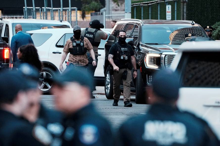 FILE PHOTO: Federal agents gather outside 26 Federal Plaza (Jacob K. Javits Federal Building) where migrants who were detained by U.S. Immigration and Customs Enforcement (ICE) were brought in, in Manhattan