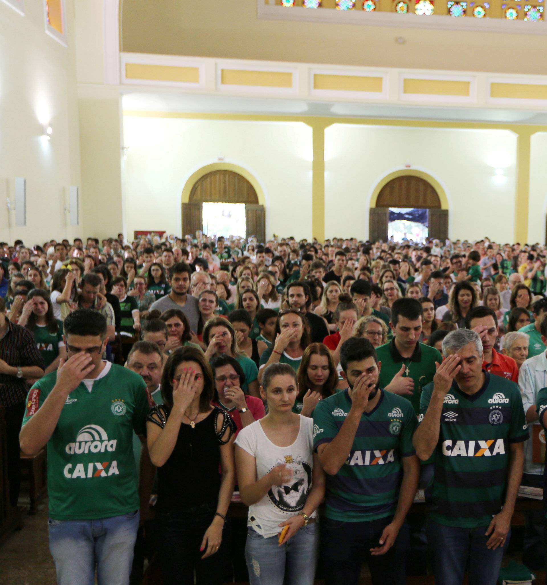 Fans of Chapecoense soccer team attend a mass at the Santo Antonio Cathedral in Chapeco