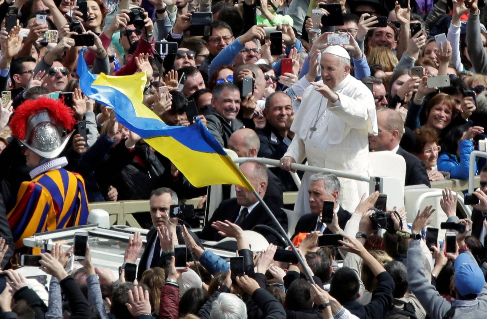 Pope Francis greets faithful from his Papamobile after the Easter Mass at St. Peter's Square at the Vatican