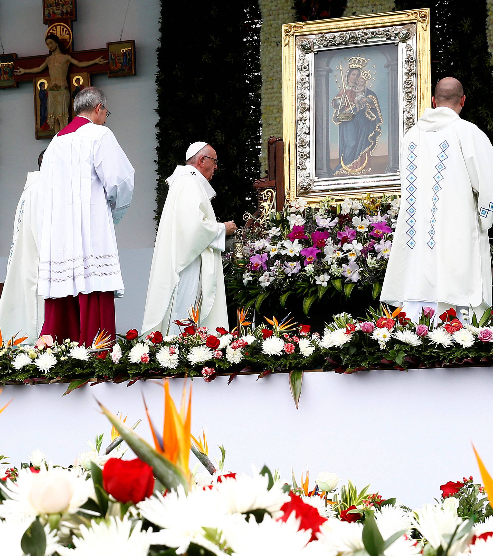 Pope Francis blesses the Virgin Mary image during the holy mass at Enrique Olaya Herrera airport in Medellin