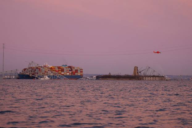 Emergency personnel work at the scene of the Francis Scott Key Bridge collapse in Baltimore