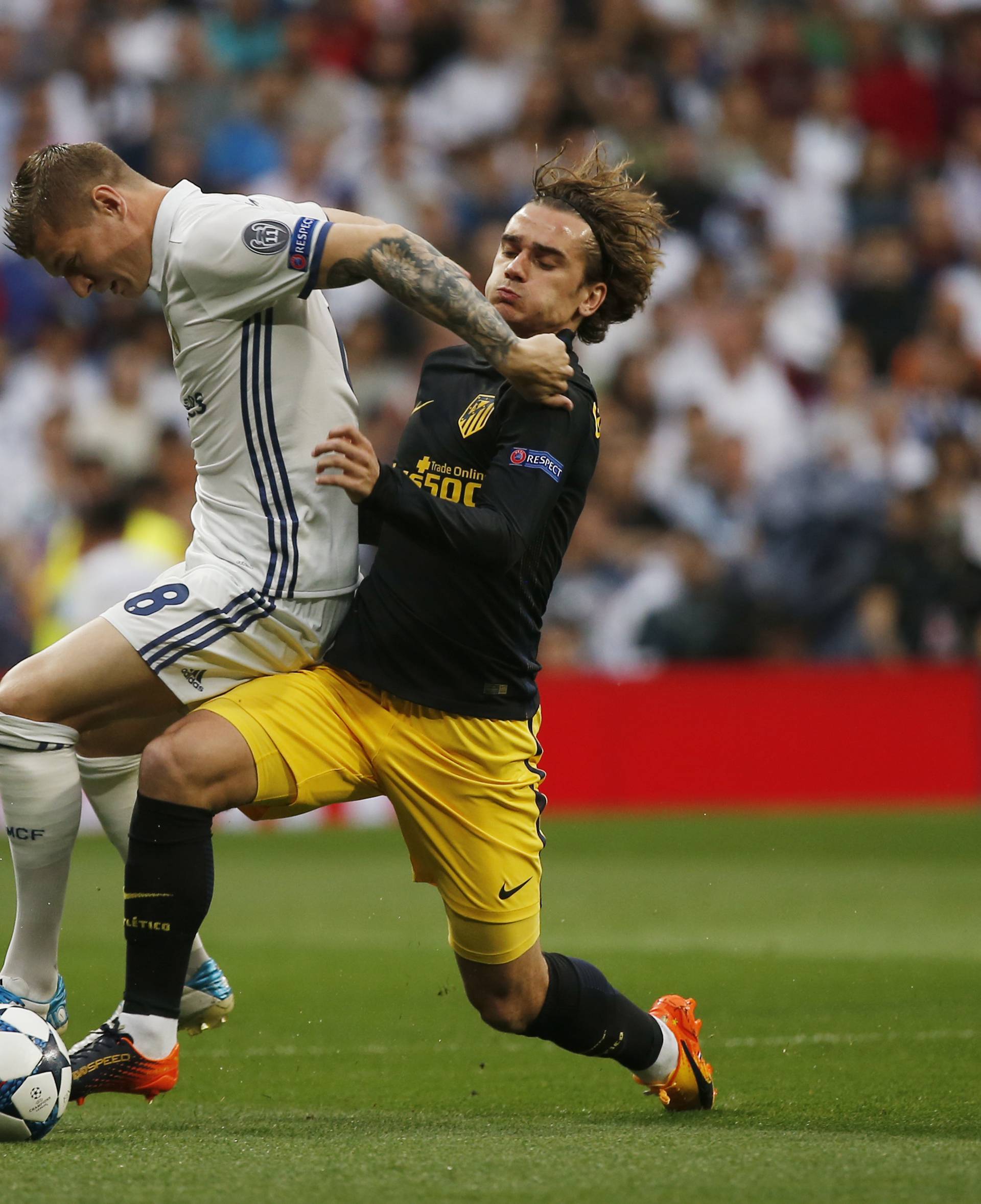 Real Madrid's Toni Kroos in action with Atletico Madrid's Antoine Griezmann