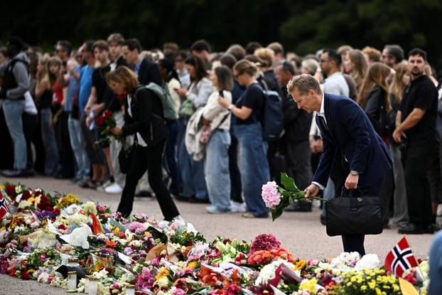 People gather outside the Royal Palace, following the death of Norway's King Harald, in Oslo