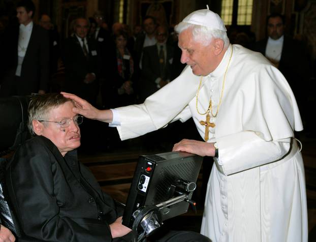 FILE PHOTO: Pope Benedict XVI greets British professor Hawking during a meeting of science academics at the Vatican