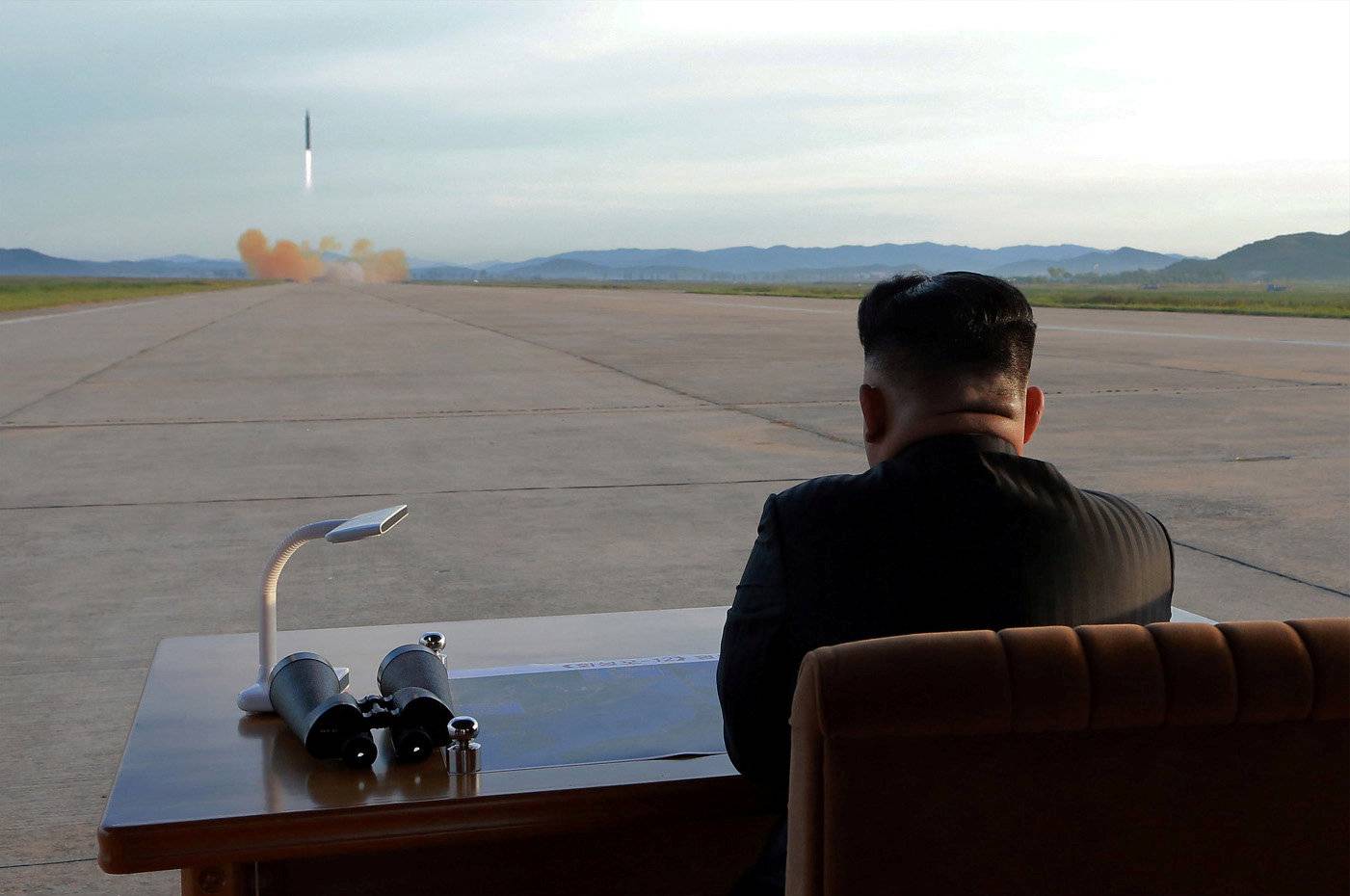 North Korean leader Kim Jong Un watches the launch of a Hwasong-12 missile in this undated photo released by North Korea's KCNA