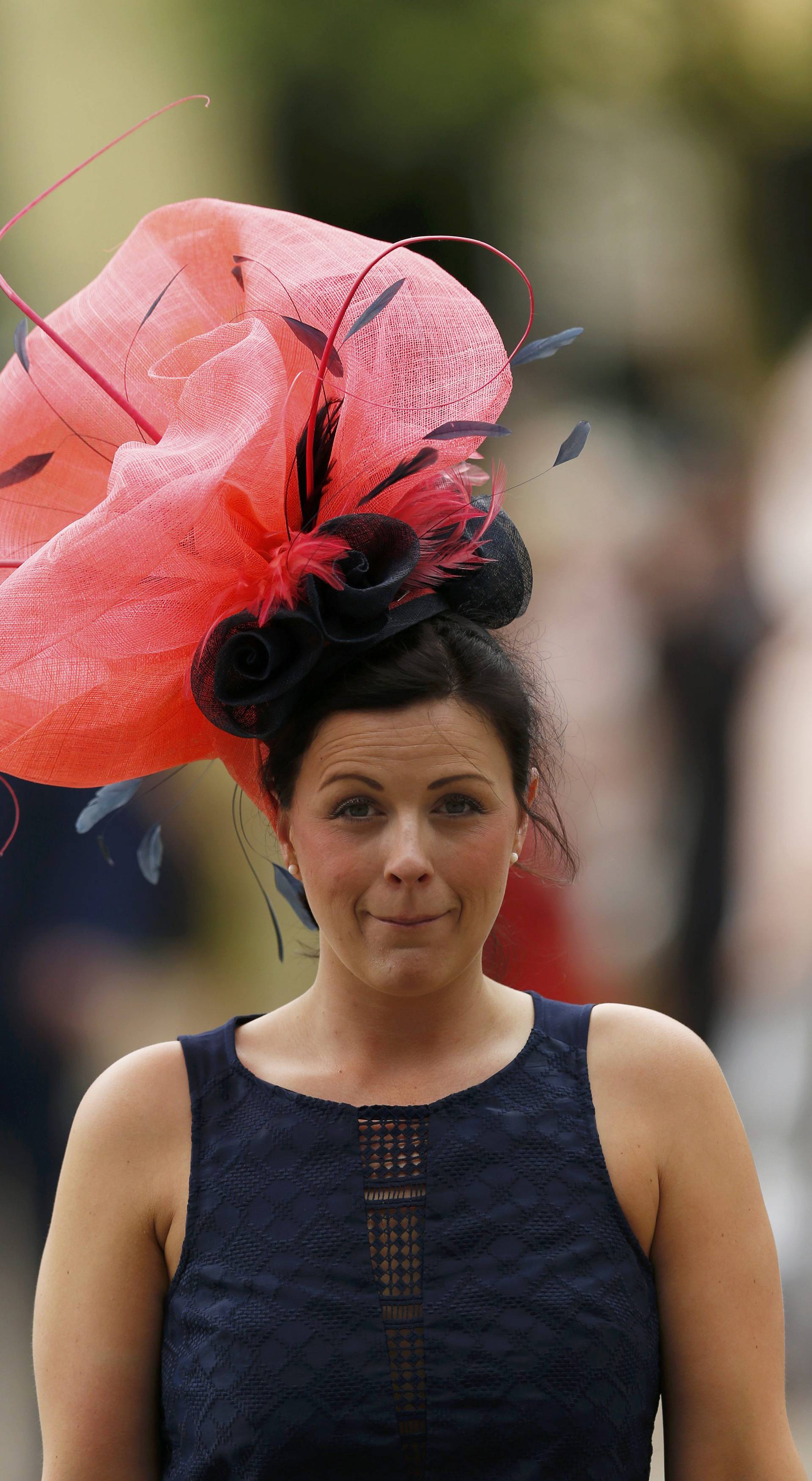 Britain Horse Racing Ladies Day Racegoer wears hat